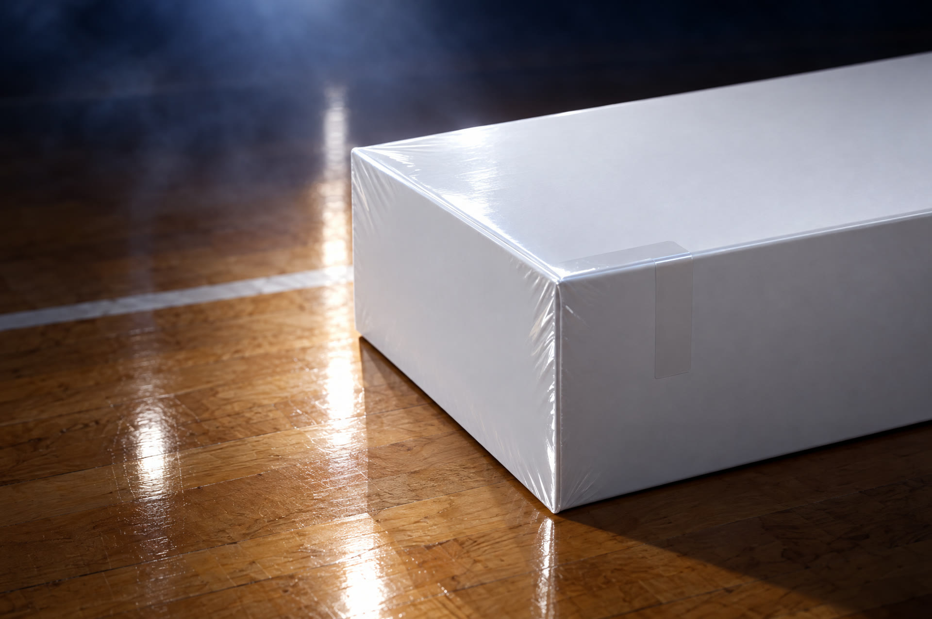 A factory sealed white box on basketball hardwood
